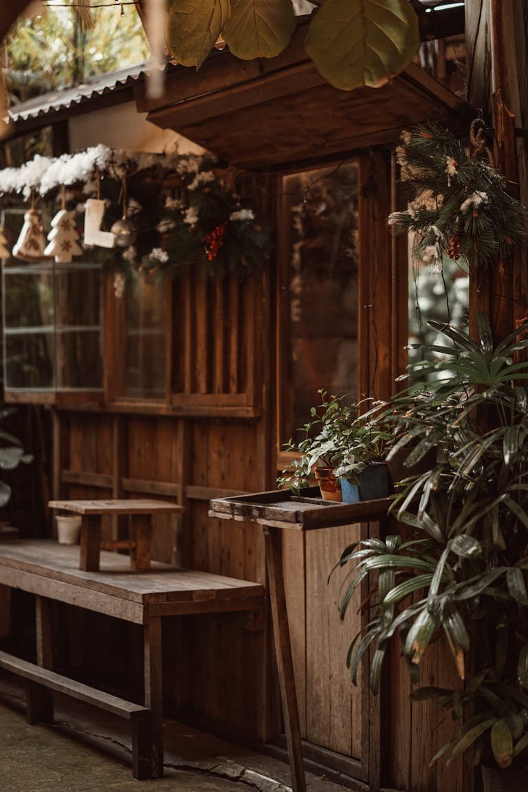 Cozy outdoor wooden space adorned with greenery and decorations, creating a rustic ambiance.