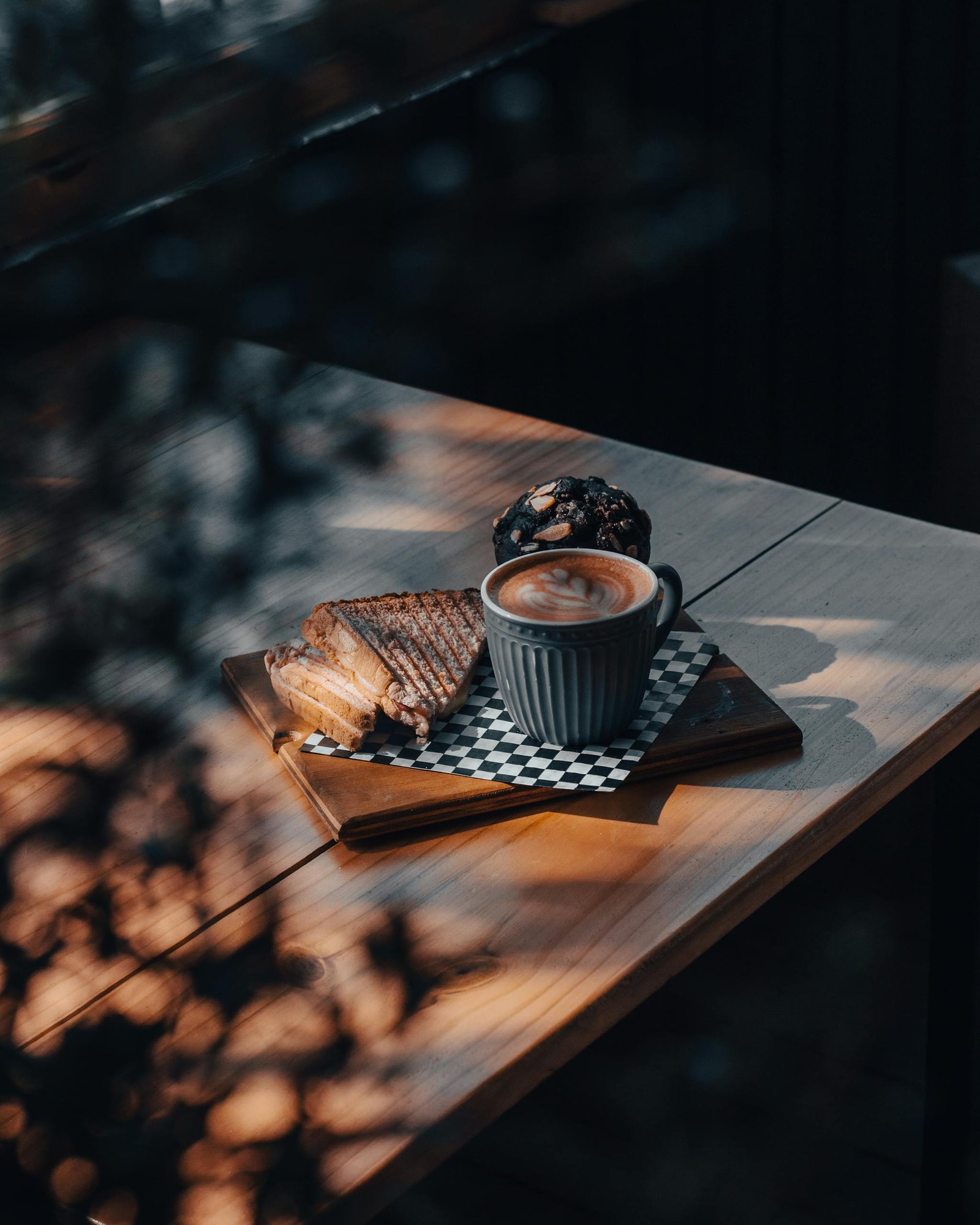 Warm setting with cappuccino and toasts on a wooden table, perfect for a cozy morning vibe.