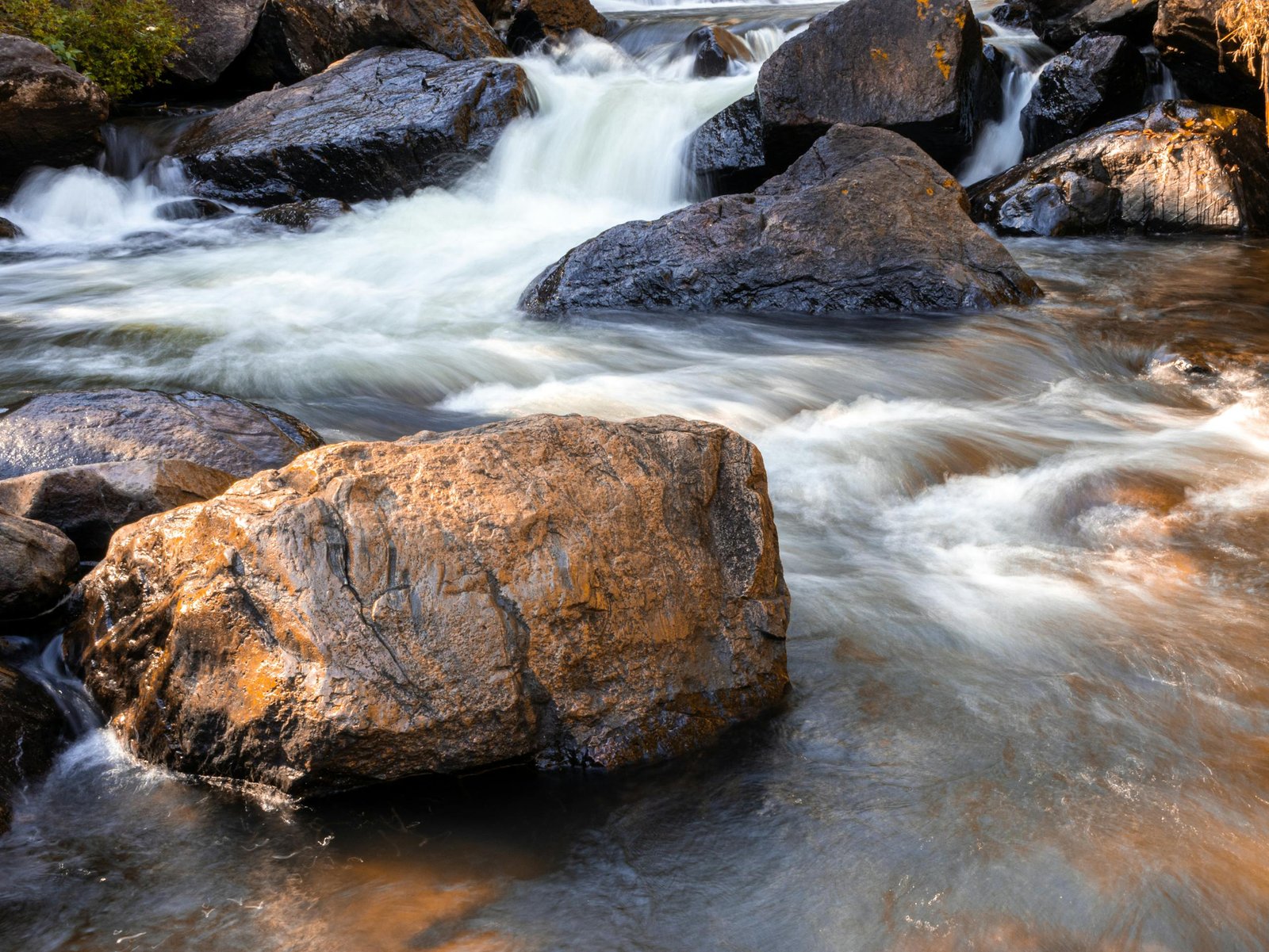 Beautiful rushing stream with large rocks in Joanópolis, São Paulo, Brazil, showcasing nature's tranquility.