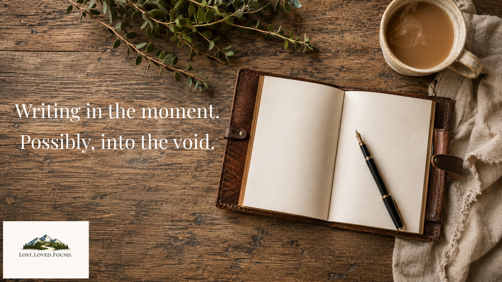 a wood table, a blank leather bound journal next to a fountain pen and a cup of coffee